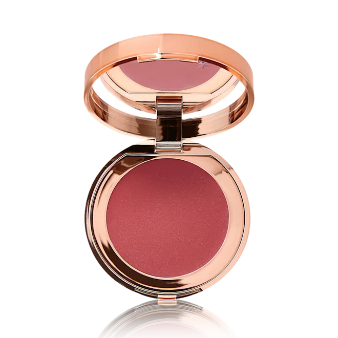Compact blush with rose gold casing on a white background