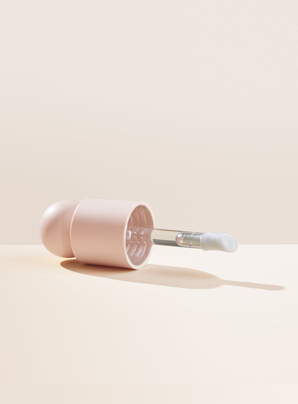 Rare Beauty Positive Light Liquid Luminizer doe-foot applicator and cap